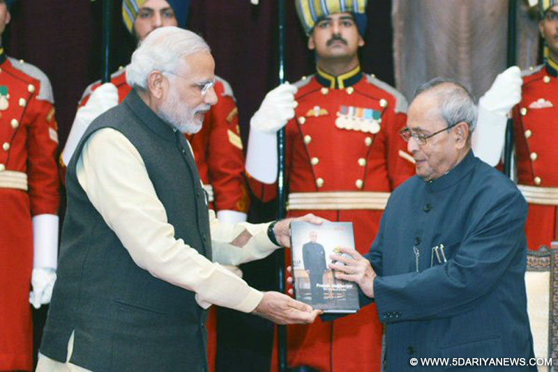 The Prime Minister, Shri Narendra Modi presenting the first copy of the released books to the President, Shri Pranab Mukherjee, at Rashtrapati Bhavan, in New Delhi on December 11, 2015.