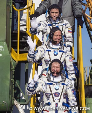 Expedition 46 Soyuz Commander Yuri Malenchenko, top, and flight engineers Tim Kopra, centre and Tim Peake, bottom wave farewell prior to boarding the Soyuz rocket for launch.