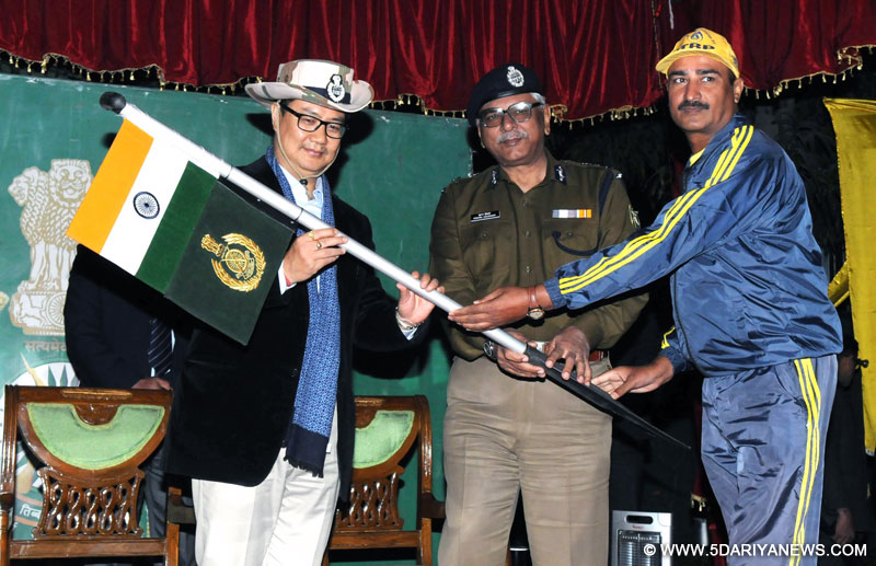 The Minister of State for Home Affairs, Shri Kiren Rijiju being presented a flag by the ITBP team leader, at the Flag-in ceremony of ITBP Ganga river rafting 