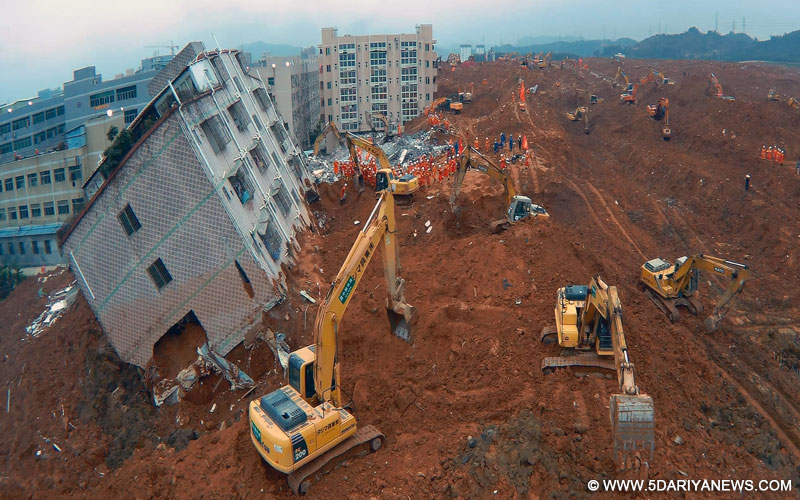 Rescuers work at the site of landslide at an industrial park in Shenzhen, south China