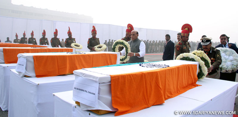 The Union Home Minister, Shri Rajnath Singh paying tributes to the BSF plane crash victims, at Safdarjung airport, in New Delhi on December 23, 2015. 