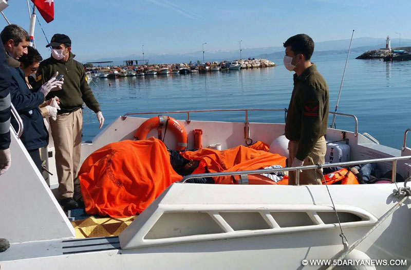 The Turkish Coast Guard members transfer bodies of drowned migrants at Edremit Bay, Turkey, on Feb. 8, 2016. A total of 33 migrants drowned were found drowned on Monday after two boats capsized off Turkey