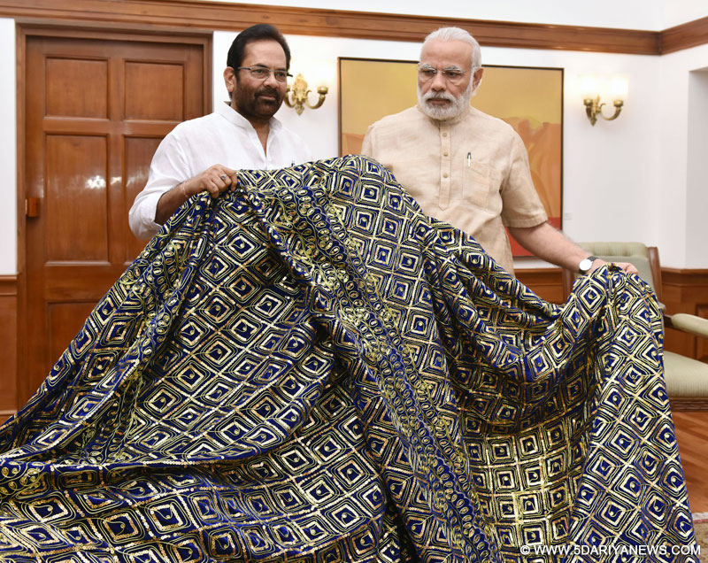 The Prime Minister, Shri Narendra Modi handing over the "Chaadar" to be offered at Dargah of Khwaja Moinuddin Chishti, Ajmer Sharif, to the Minister of State for Minority Affairs and Parliamentary Affairs, Shri Mukhtar Abbas Naqvi, in New Delhi on April 09, 2016.