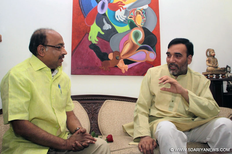  Delhi Transport Minister Gopal Rai meets BJP MP Vijay Goel at his residence to persuade him not to violate the odd-even traffic scheme aimed at battling pollution in New Delhi, on April 18, 2016. 