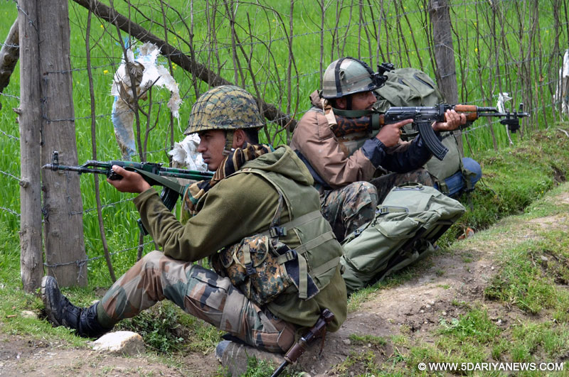  Lolab: Soldiers take position during an encounter with militants in Lolab of Jammu and Kashmir, on April 21, 2016.