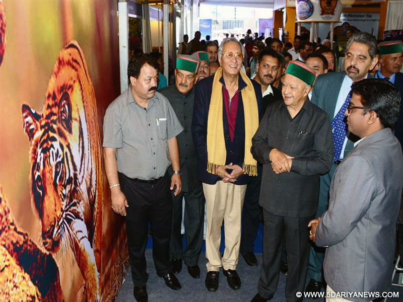 Chief Minister  Virbhadra Singh evincing keen interest in tourism stalls set up by various states after opening of Himachal Travel Mart at the Ridge in Shimla on 22-04-16.