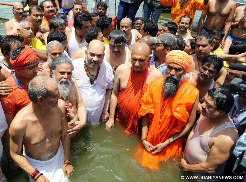 BJP chief Amit Shah takes a holy dip in the Shipra river during Ardh Kumbh Mela in Ujjain on May 11, 2016. 