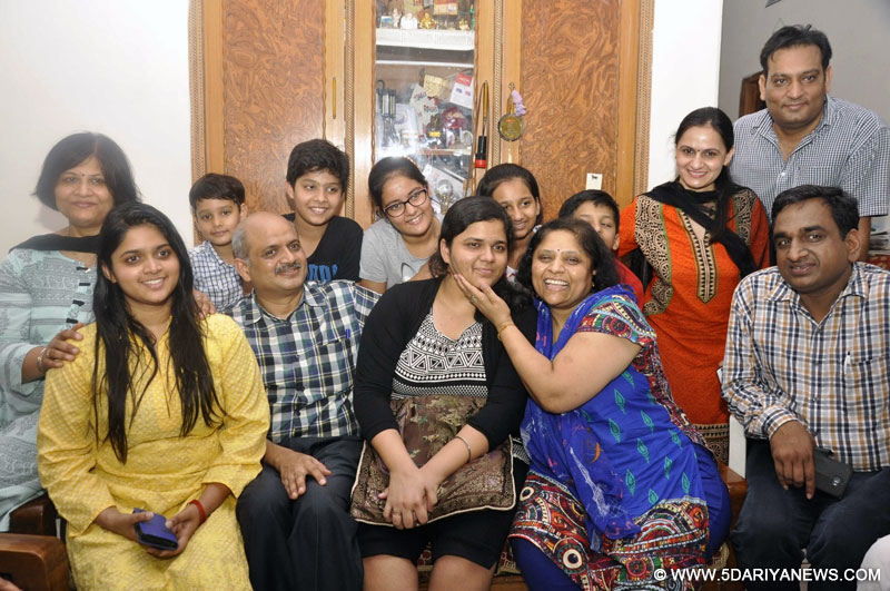 Sukriti Gupta,topped the class 12 examination of the Central Board of Secondary Education (CBSE), securing 99.4 percent marks celebrates with her parents in New Delhi on May 21, 2016.