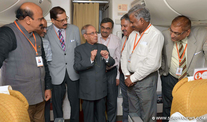 The President, Shri Pranab Mukherjee interacting with the accompanying officials, academic and media delegation on board, Air India Special aircraft on his way to Guangzhou, People’s Republic of China on May 24, 2016.
