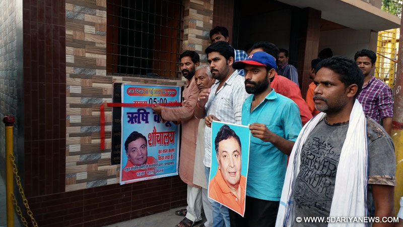 Congress workers paste pictures of actor Rishi Kapoor at a public toilet apparently as a retort to the actor