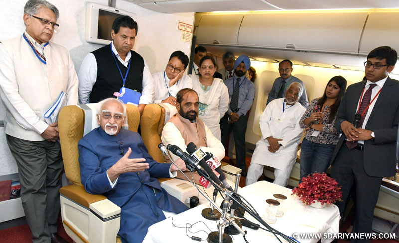 M. Hamid Ansari interacting with the accompanying media delegation on board, Air India Special aircraft on his way to Morocco and Tunisia visit, on May 30, 2016. The Minister of State for Chemicals & Fertilizers, Shri Hansraj Gangaram Ahir is also seen.
