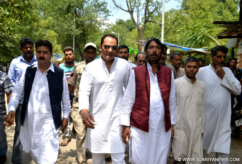 Congress leader and former cricketer Mohammad Azharuddin with Jammu and Kashmir Congress chief G A Mir during a road show in Anantnag on June 20, 2016. 