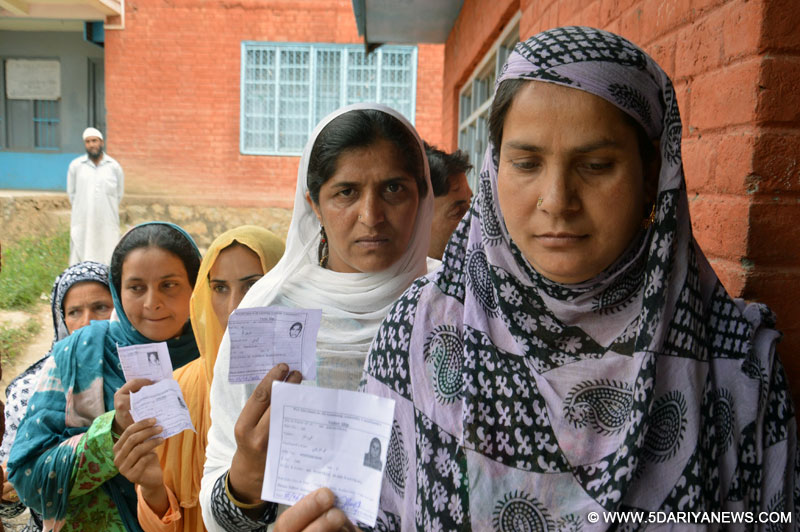 Women queue-up outside a polling booth during by-elections to Anantnag assembly seat in Kashmir on June 22, 2016.