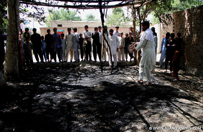 People gather at the blast site in Behsoud district of Nangarhar province, Afghanistan, June 22, 2016. Two people including a child were killed as a bomb planted by militants went off in Behsoud district of the eastern Nangarhar province in Afghanistan on Wednesday, spokesman for provincial government Attaullah Khogiani said. 