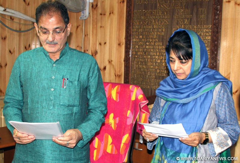 Jammu and Kashmir Chief Minister Mehbooba Mufti takes oath as a member of the state legislative assembly in Srinagar, on June 30, 2016. Also seen speaker of the assembly Kavinder Gupta.