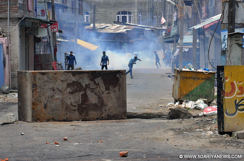 Youths pelt stones on security personnel in Srinagar on July 10, 2016. The death toll in violence in Kashmir Valley on Sunday rose to 16 after a youth was killed and four other persons succumbed to the injuries they sustained in Saturday