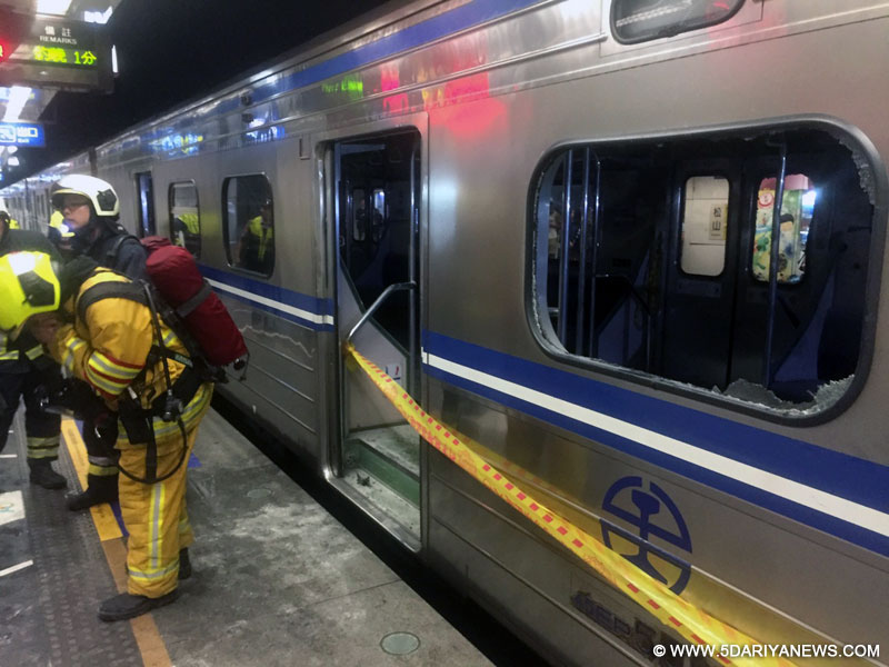 Rescuers work at the explosion site of a commuter train in Taipei, southeast China