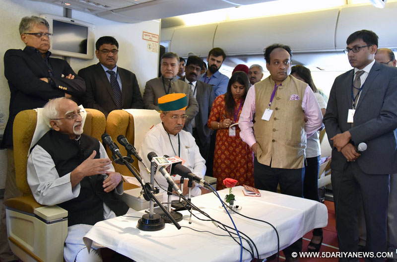 The Vice President, Shri M. Hamid Ansari interacting with the accompanying media onboard Air India Special Flight on his way to Nigeria, on September 26, 2016. The Minister of State for Finance, Shri Arjun Ram Meghwal is also seen.