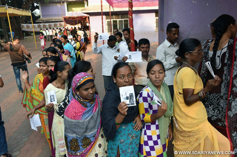 Voters show their voter ID cards as they wait in a queue to cast their vote at a polling booth during Goa Legislative Assembly polls in Chimbel, Goa on Feb 4, 2017.