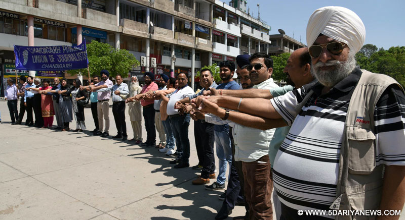 Members of the Chandigarh-Punjab Union of Journalists (CPUJ) forming a human chain by holding hands of one another on May Day Rally at Sector - 17 Plaza on Monday at Chandigarh.