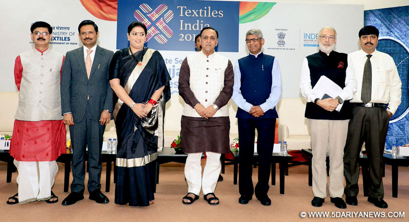 The Union Minister for Textiles, Smt. Smriti Irani witnessing the exchange of an MoU at the Gujarat State Session titled “Opportunities & challenges for next generation”, at Textiles India 2017, in Gandhinagar, Gujarat on July 01, 2017. The Chief Minister of Gujarat, Shri Vijay Rupani and the Secretary, Ministry of Textiles, Shri Anant Kumar Singh are also seen.