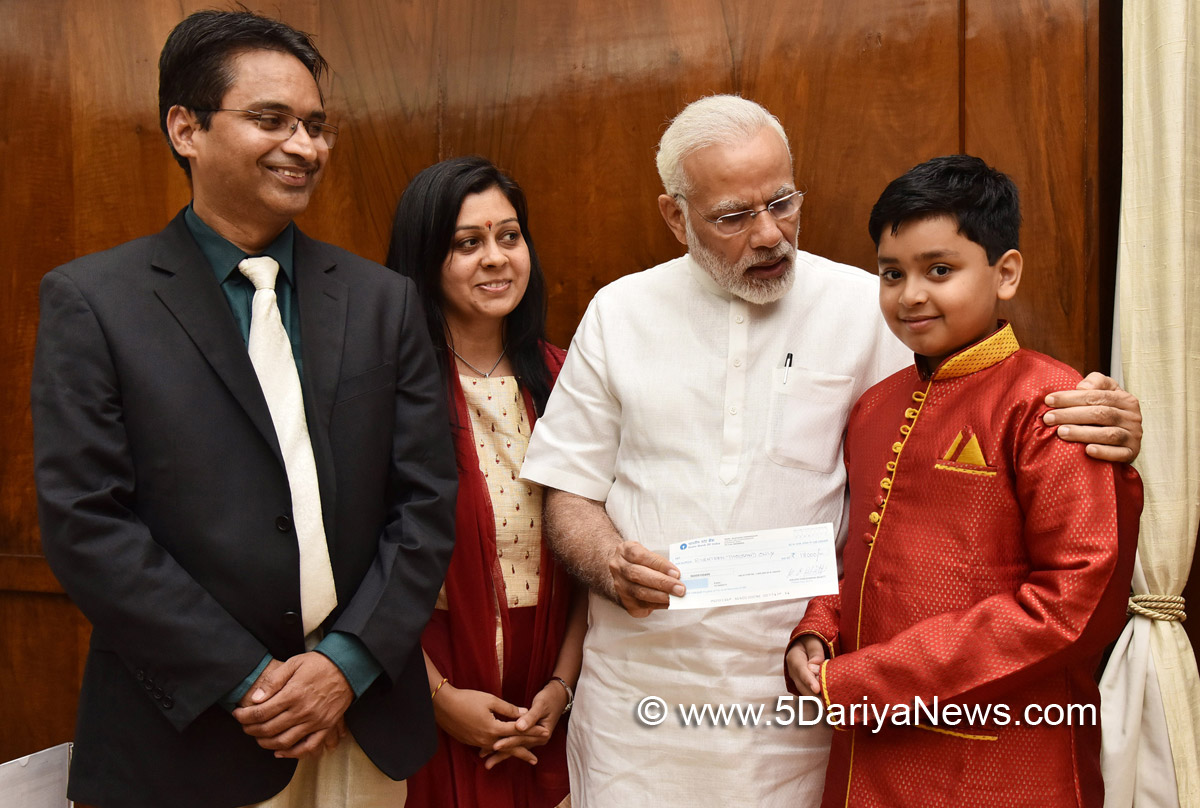 Kuwait NRI student Riddhiraj presents a cheque of his Prize Money to the Prime Minister, Shri Narendra Modi, as donation for the Indian Army Welfare Fund, in New Delhi on August 03, 2017.