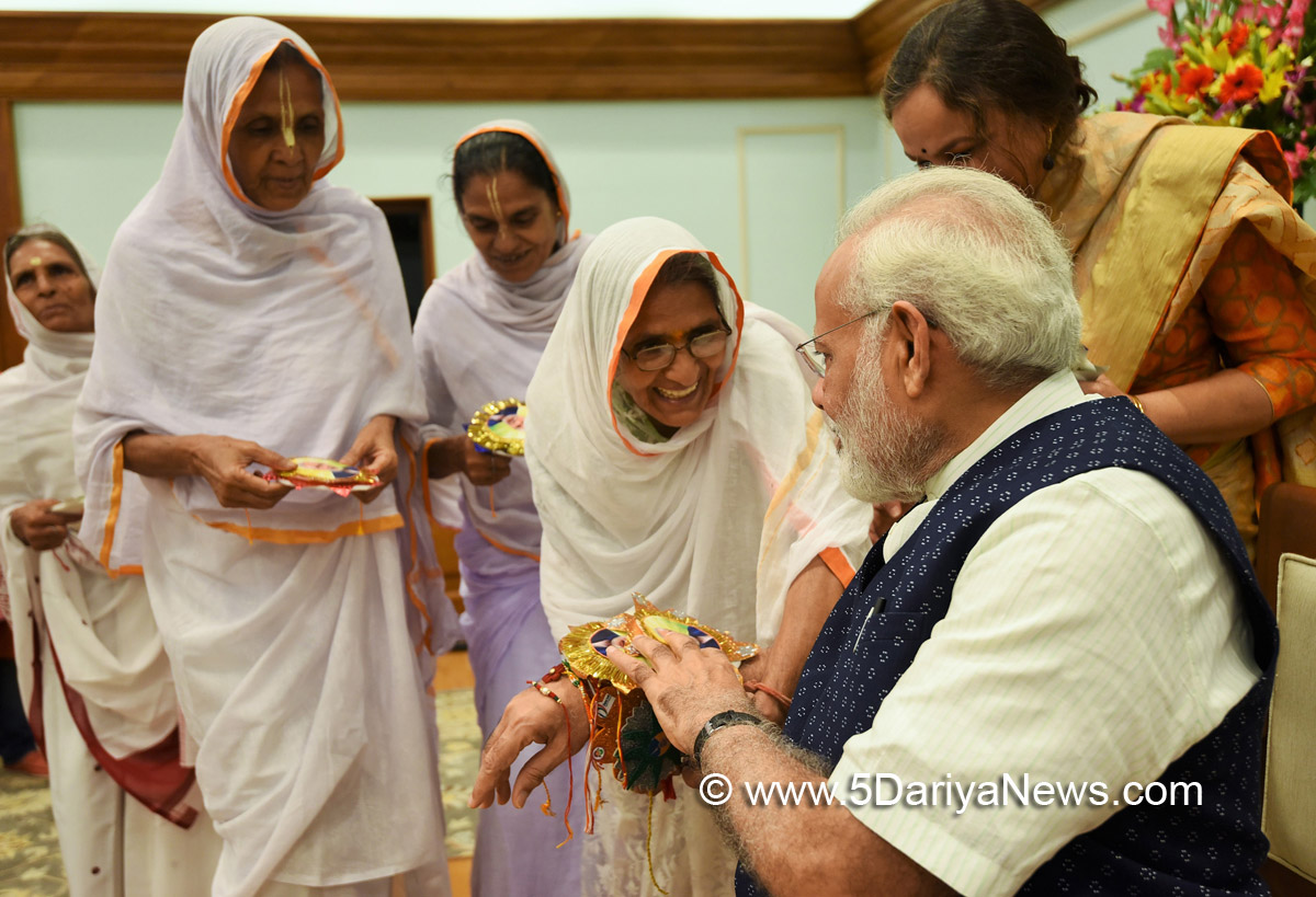 Women tying ‘Rakhi’ on the Prime Minister, Shri Narendra Modi’s wrist, on the occasion of ‘Raksha Bandhan’, in New Delhi on August 07, 2017. 