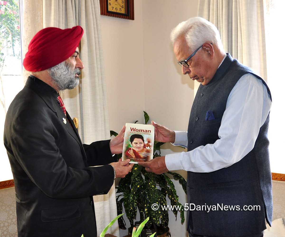 Former Navy Officer presents his book, “Woman of Substantial Character” to Governor N.N. Vohra