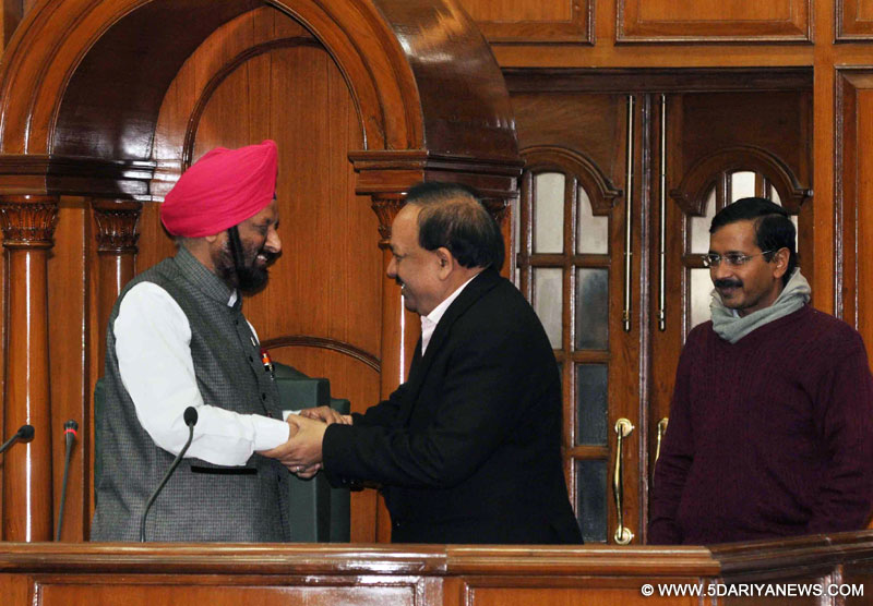 BJP leader Harsh Vardhan greets Aam Aadmi Party (AAP) legislator and newly elected speaker of Delhi Legislative   Assembly MS Dhir inside the house in New Delhi on Jan.3, 2014.