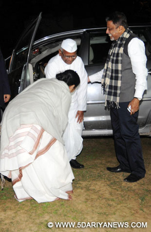 West Bengal Chief Minister Mamata Banerjee touches the feet of social activist Anna Hazare in New Delhi on Feb.18, 2014. Trinamool Congress general secretary Mukul Roy also seen. 