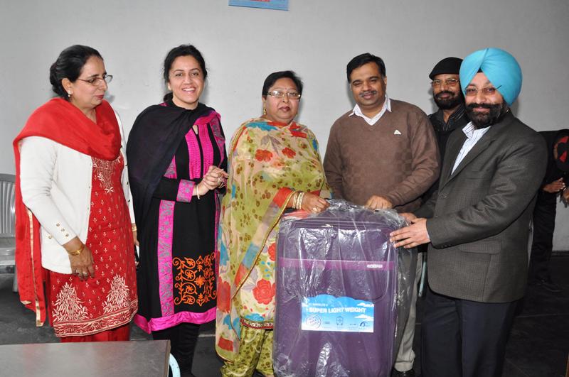 Mr. D. S Mangat Director Information & Public Relations Department and Additional Director Press Dr. Senu Duggal presenting a gift on the occasion of Retirement party of Dr. Uma Sharma Deputy Director in Punjab Civil Secretariat Chandigarh on January 31, 2013. 
