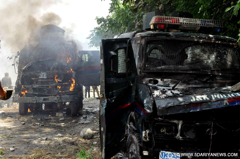 Violent protesters set on fire two police vehicles at Aaripal Village in Tral, after a non-local militant was killed in an encounter with forces in Tral District Pulwama of Jammu and Kashmir on July 5, 2014.