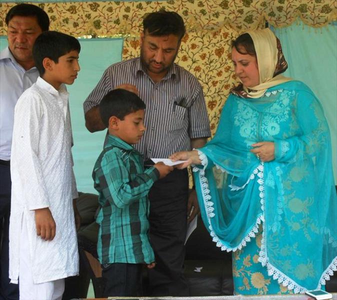 Minister for Social Welfare, Sakina Itoo distributing scholarship cheques among militancy affected school going children under Militancy affected Rehabilitation Scheme at Baramulla