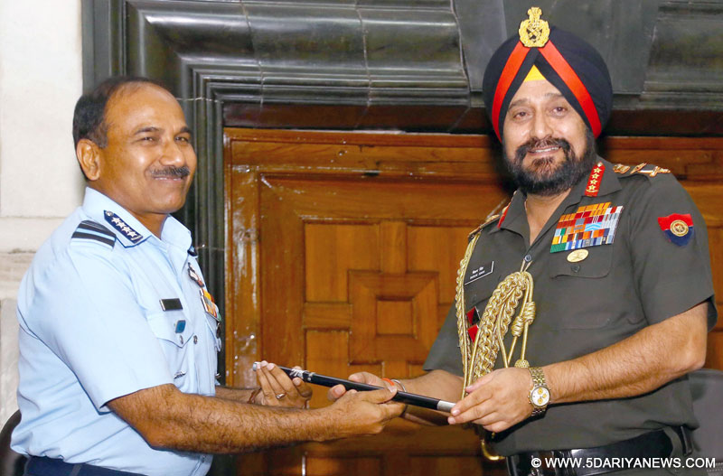 The outgoing Chairman, Chief of Staff Committee (COSC) and Chief of Army Staff, General Bikram Singh handing over the COSC baton to the new Chairman, Chief of Staff Committee (COSC) and Chief of the Air Staff, Air Chief Marshal Arup Raha, in New Delhi on July 30, 2014. 