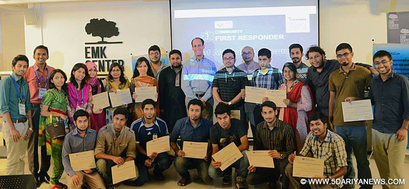 Selected number of youth leaders striking a pose showing their certificates of accomplishment at the end of event 