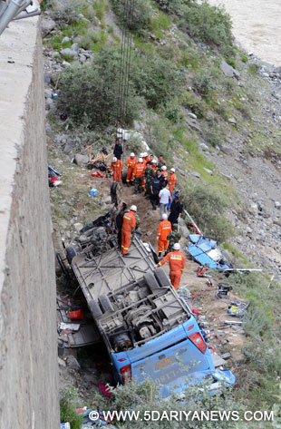 Rescuers work on the scene of a three-vehicle pile-up in Nyemo County, southwest China