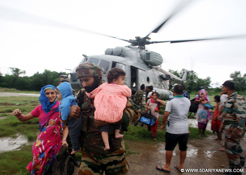 The Indian Air Force Helicopters carrying out rescue, relief and evacuation of people marooned during the flood fury