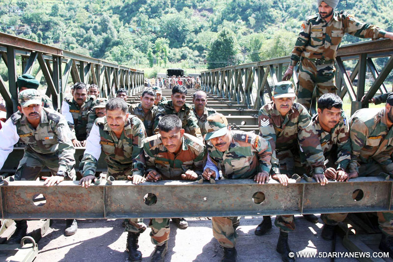 Army personnel are building bridge on a war footing over Poonch River on Jammu-Poonch National Highway to connect Poonch 