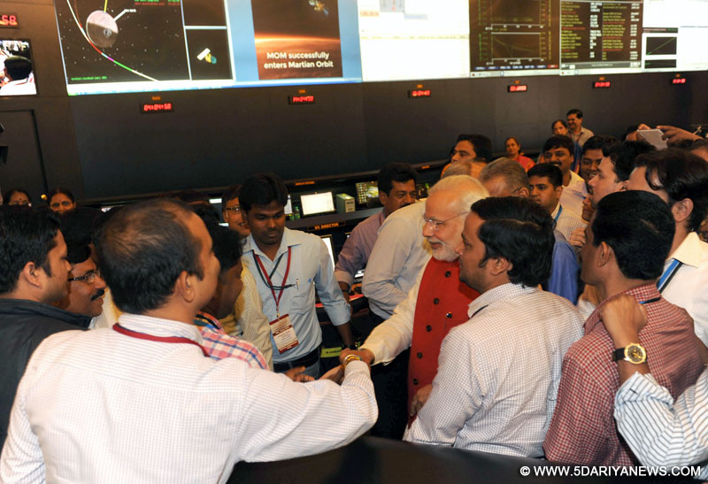 Narendra Modi congratulating ISRO scientists after successful Insertion of Mars Orbiter (Mangalyan) into the Mars orbit, at ISRO Headquarters, in Bengaluru on September 24, 2014.