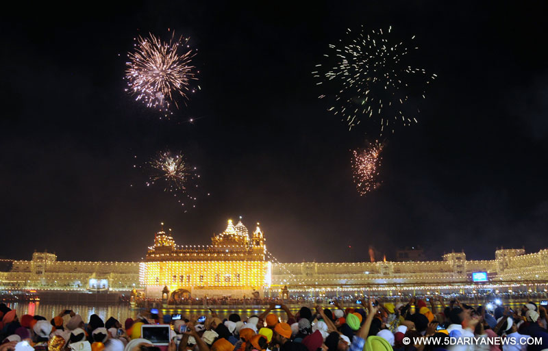 Fire works light up the sky above the Golden Temple in Amritsar on Oct. 23, 2014