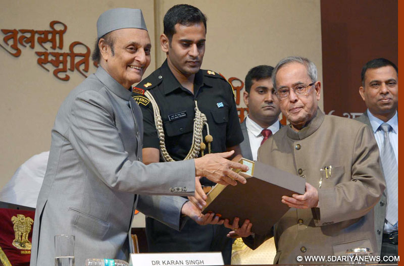Pranab Mukherjee receiving the first copy of “Tulsi Smriti Granth” on Acharya Tulsi, at Rashtrapati Bhavan, in New Delhi on October 26, 2014.